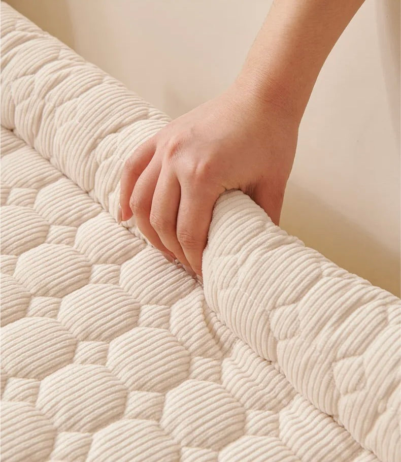 Close-up of a hand touching the soft corduroy texture of the Oasis cushion
